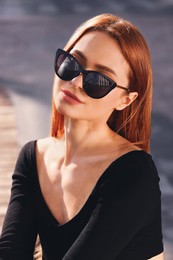 Photo of Beautiful woman in sunglasses outdoors on sunny day