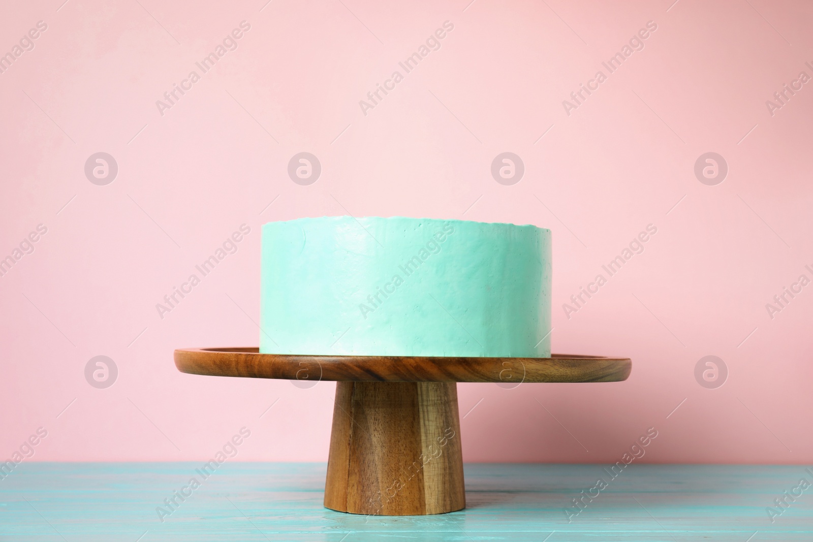 Photo of Fresh delicious birthday cake on stand against color background