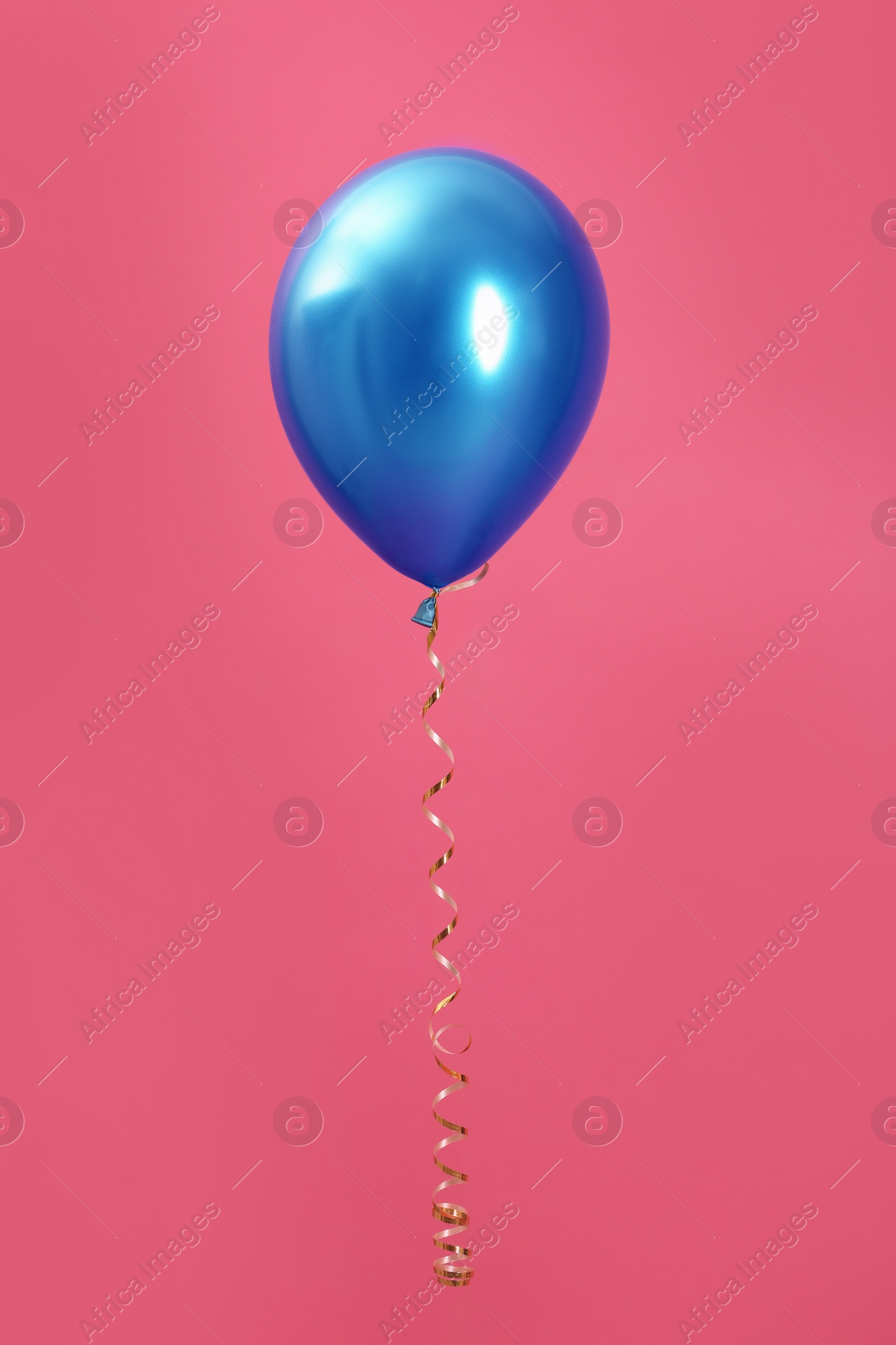 Photo of Bright balloon with ribbon on color background