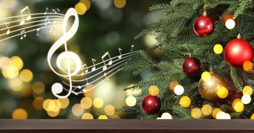 Music notes and table near Christmas tree on blurred background, bokeh effect. Banner design with space for text