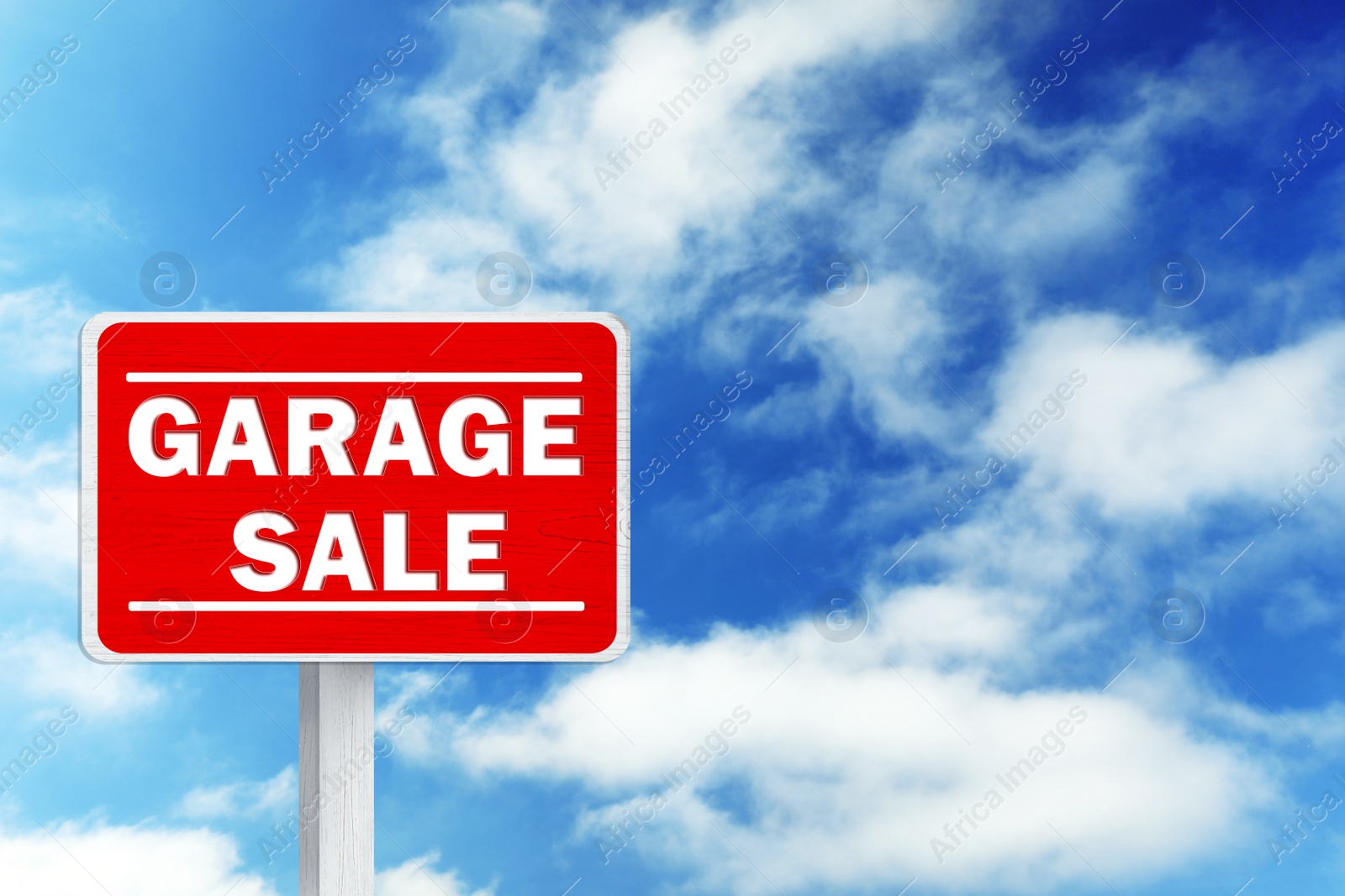 Image of Sign with phrase GARAGE SALE and blue sky