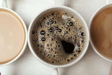 Cup with tasty aromatic coffee on table