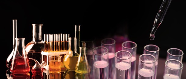 Chemistry and chemical research. Collage of different laboratory glassware with liquids on black background, color tone effect. Banner design