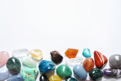 Photo of Different beautiful gemstones on white background, top view