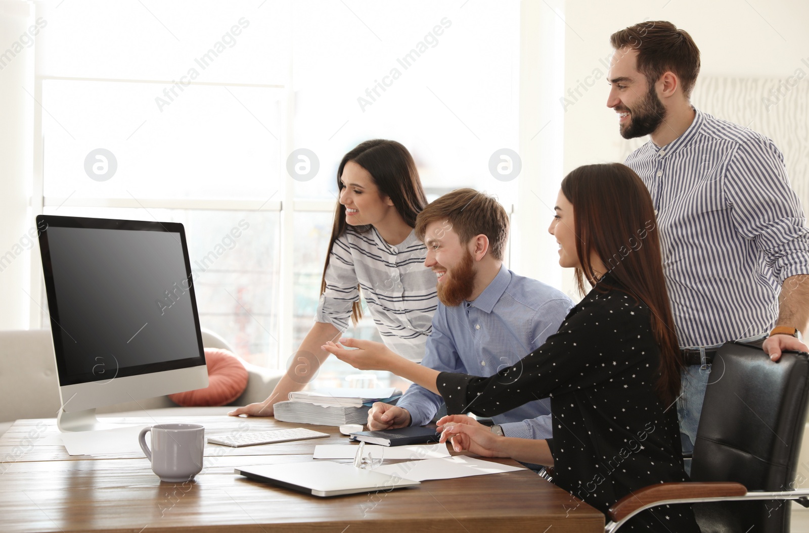 Photo of Group of colleagues using video chat on computer in office. Space for text