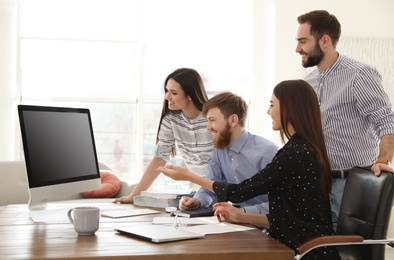 Group of colleagues using video chat on computer in office. Space for text