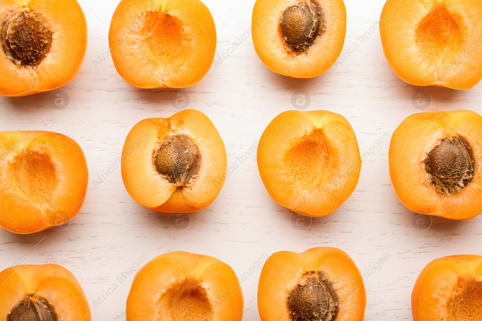 Photo of Flat lay composition with delicious ripe apricots on white wooden background