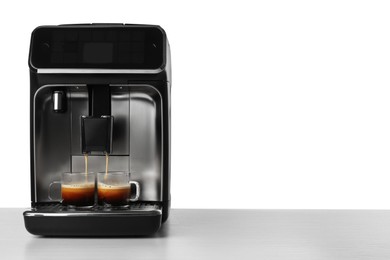 Photo of Making coffee with modern espresso machine on table against white background. Space for text