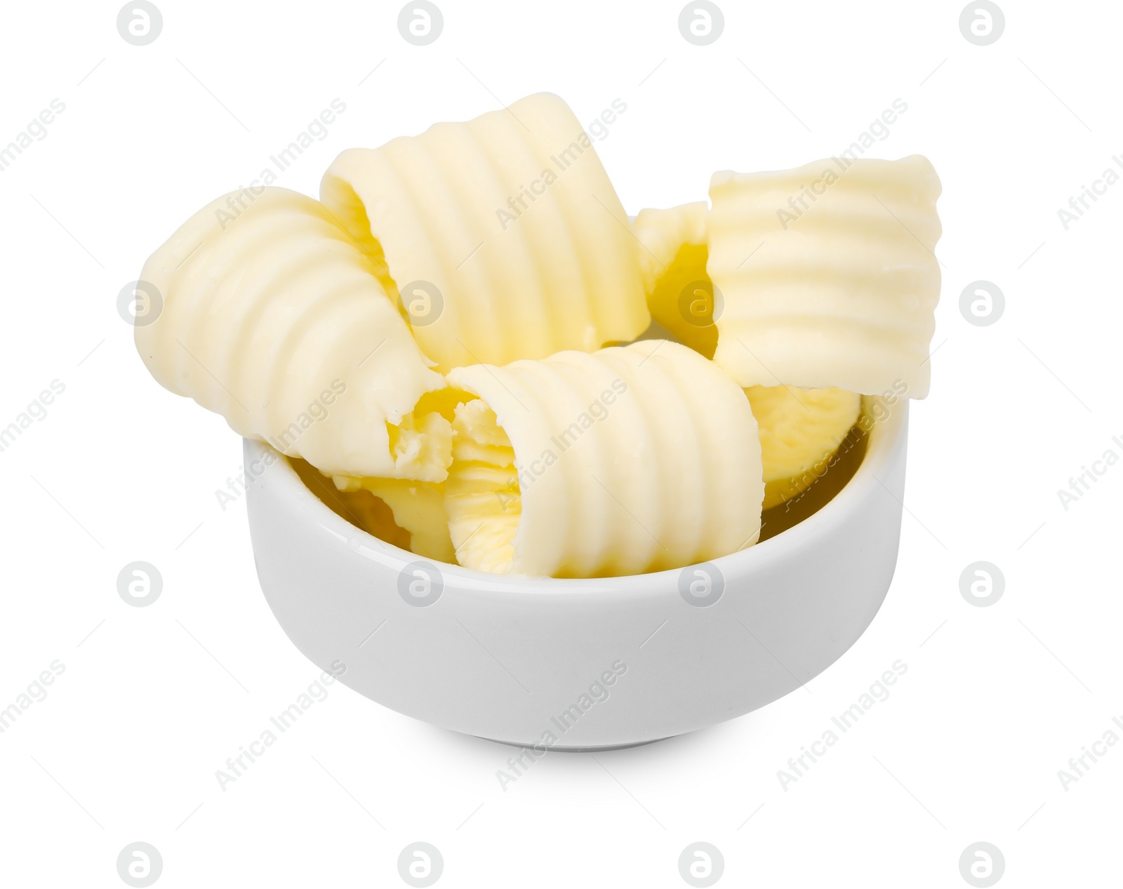 Photo of Tasty butter curls in bowl isolated on white