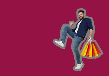 Happy man with shopping bags on pink background, space for text