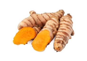 Photo of Whole and cut turmeric roots isolated on white