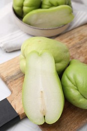 Photo of Cut and whole chayote on light table, closeup