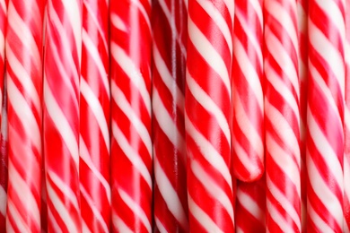 Photo of Many sweet Christmas candy canes as background, closeup