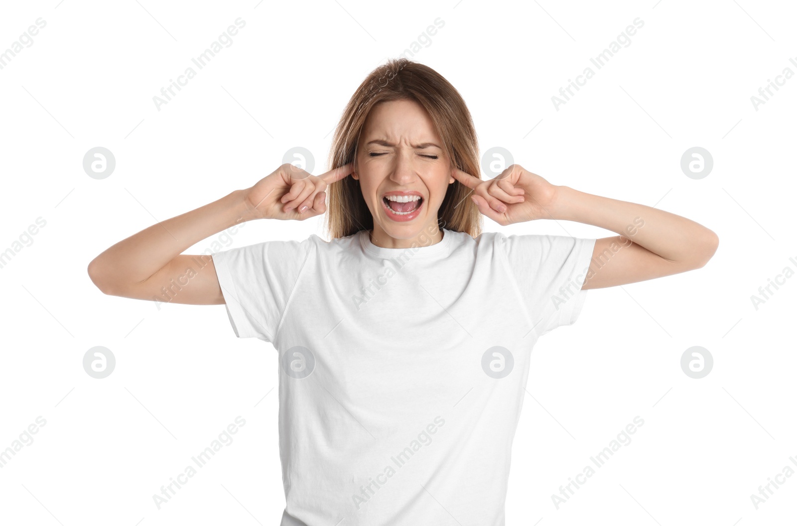 Photo of Emotional young woman covering her ears with fingers on white background