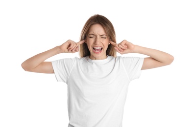 Emotional young woman covering her ears with fingers on white background