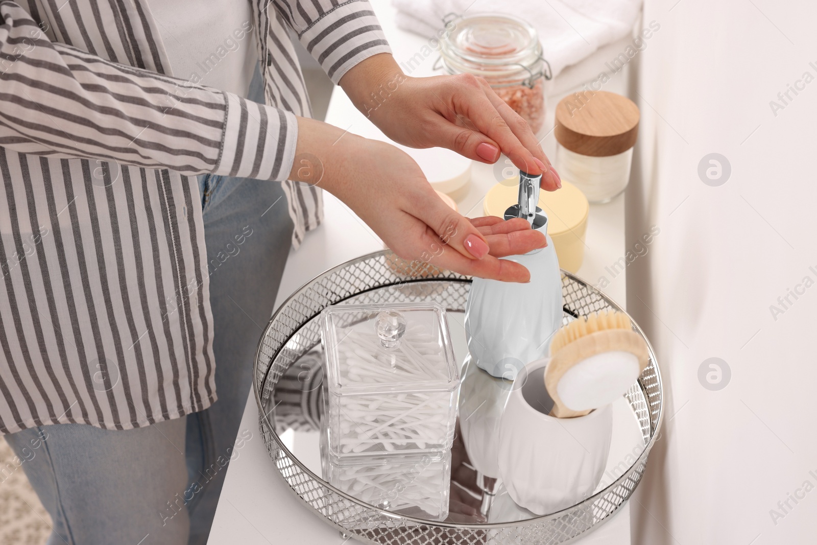 Photo of Bath accessories. Woman applying soap on her hand indoors, closeup