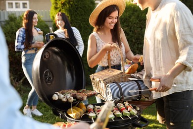Photo of Groupfriends having barbecue party outdoors