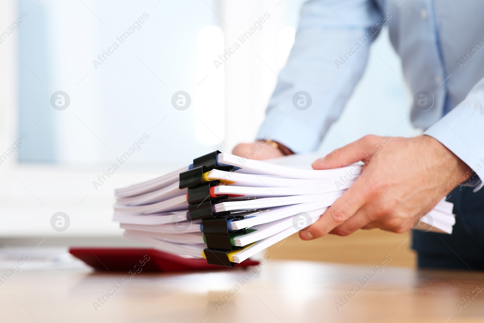 Photo of Businessman with documents in office, closeup view