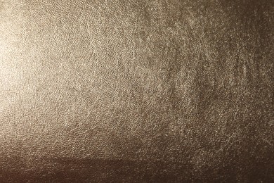 Photo of Texture of light brown leather as background, closeup