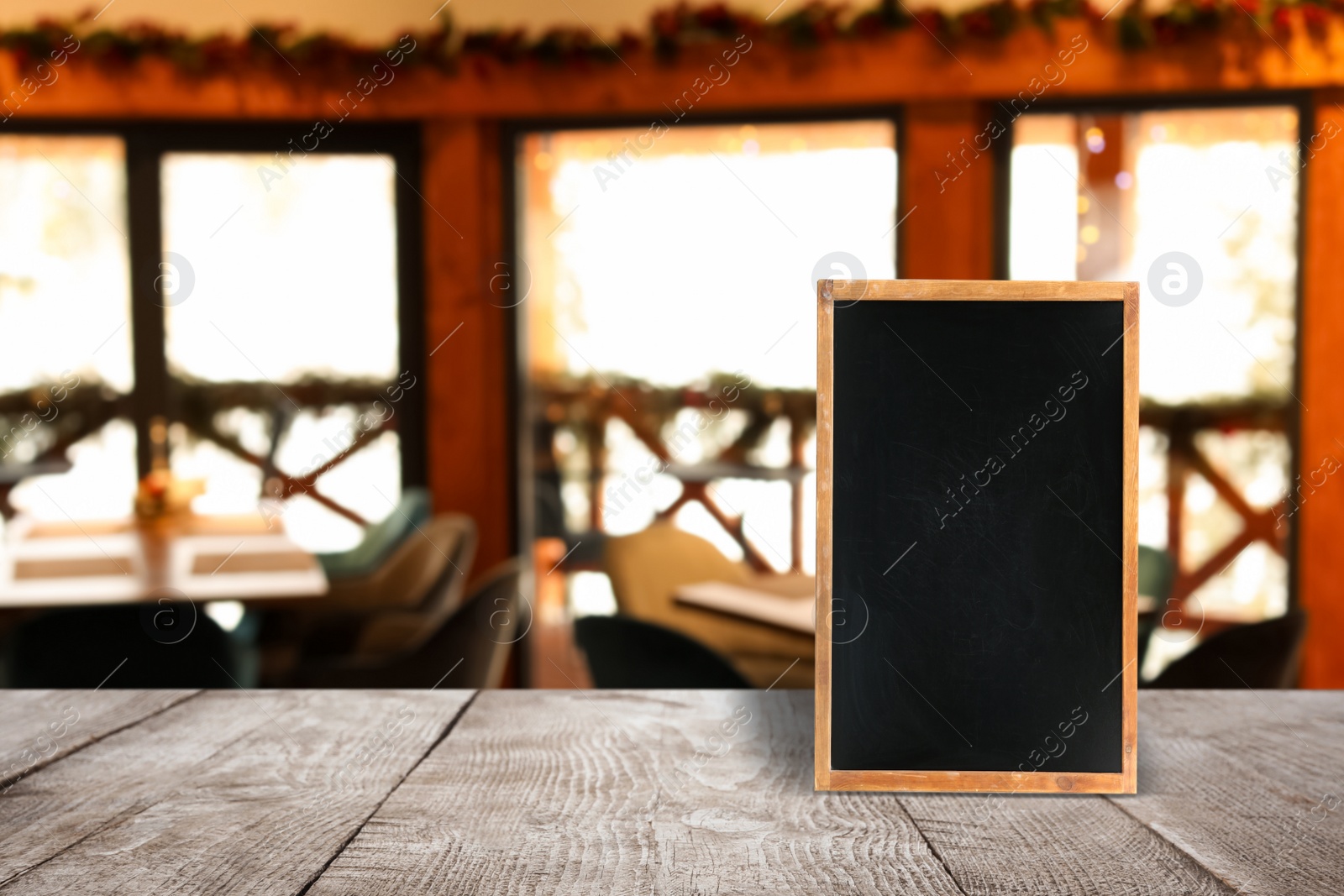 Image of Blank small blackboard on wooden table in cafe, mockup for menu design 