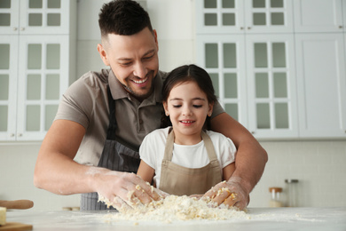 Photo of Father and daughter cooking together in kitchen