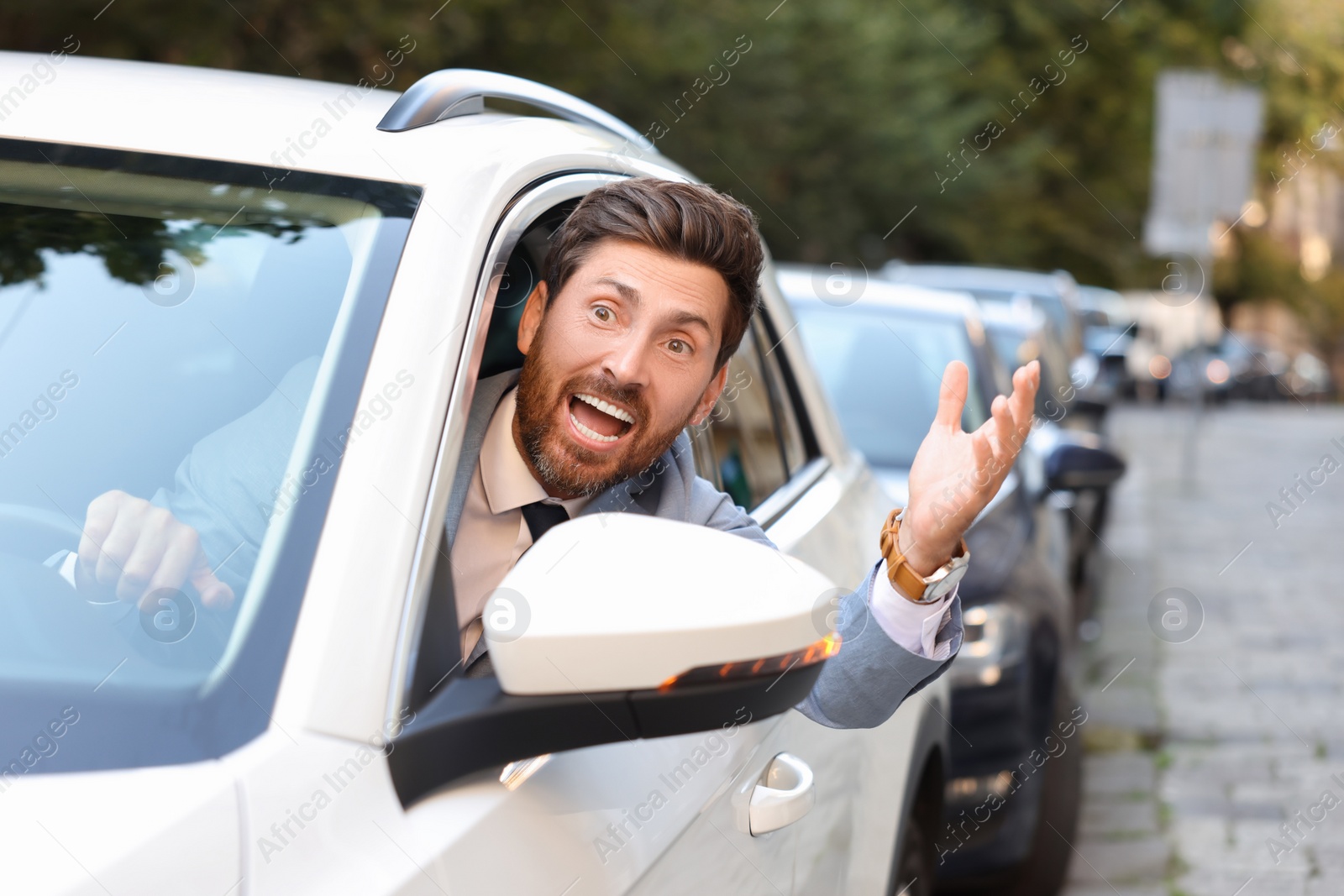 Photo of Angry driver screaming at someone from car in traffic jam