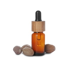 Photo of Bottle of nutmeg oil and nuts on white background