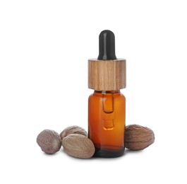 Bottle of nutmeg oil and nuts on white background