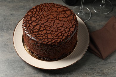 Delicious chocolate truffle cake on grey textured table