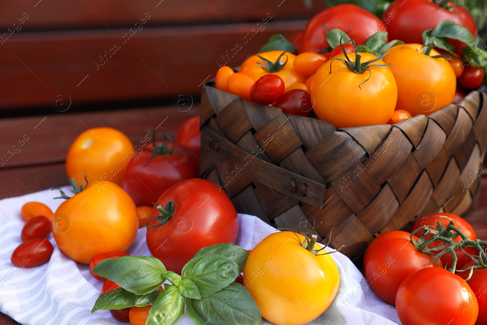 Photo of Different sorts of tomatoes on wooden bench