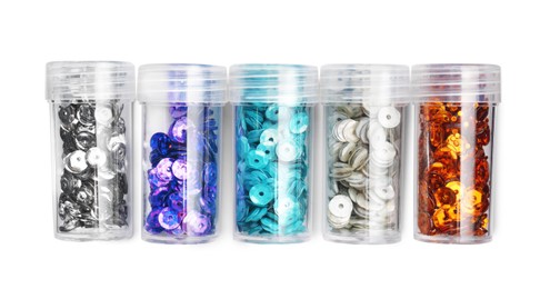 Colorful sequins in containers on white background, top view