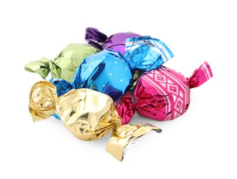 Pile of sweet candies in colorful wrappers on white background