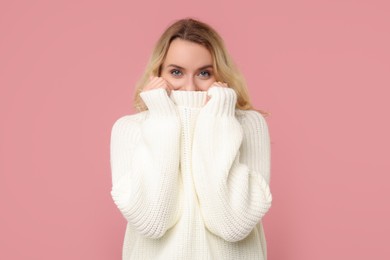 Photo of Beautiful woman in stylish warm sweater on pink background