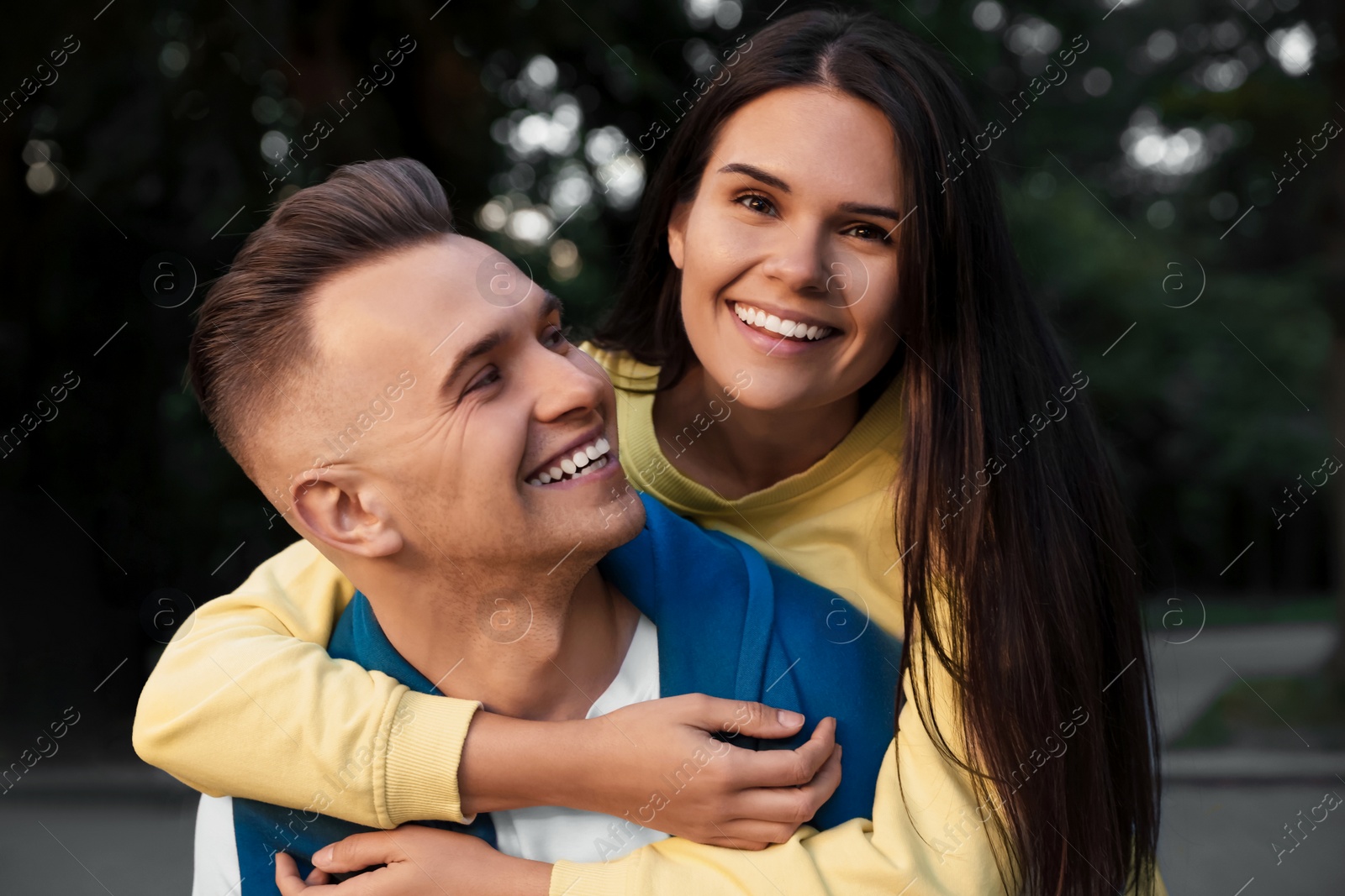 Photo of Affectionate young couple having good time together on city street