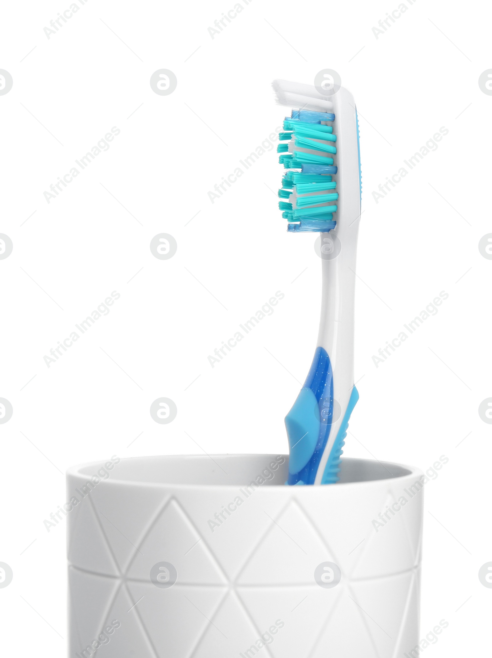 Photo of One plastic toothbrush in holder isolated on white