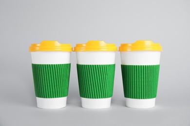 Photo of Carton cups on grey background. Mock up for design