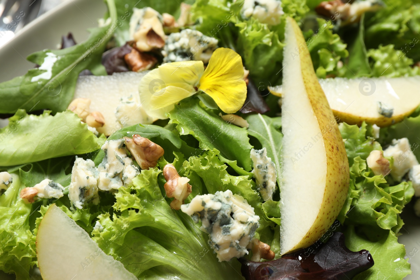 Photo of Delicious fresh salad with pear slices as background, closeup view