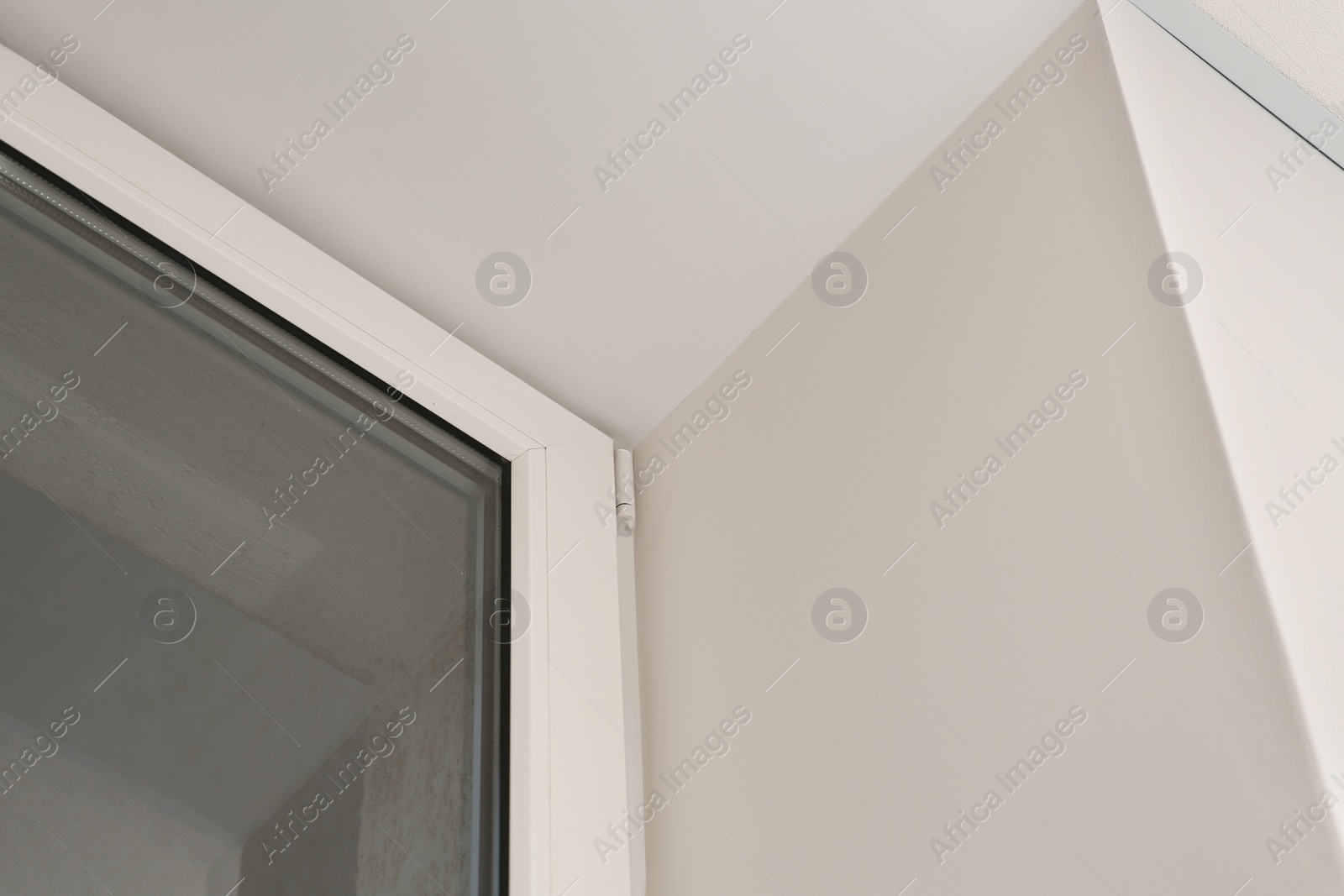 Photo of Glass plastic window near white wall indoors, low angle view