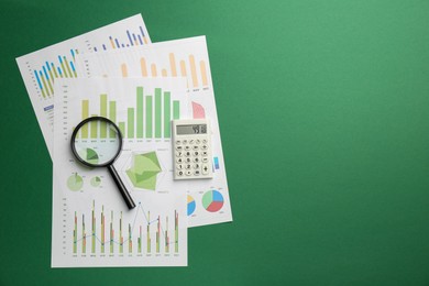 Accounting documents, magnifying glass and calculator on green background, top view. Space for text