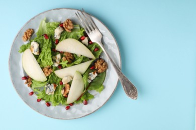 Photo of Delicious pear salad on light blue background, top view. Space for text