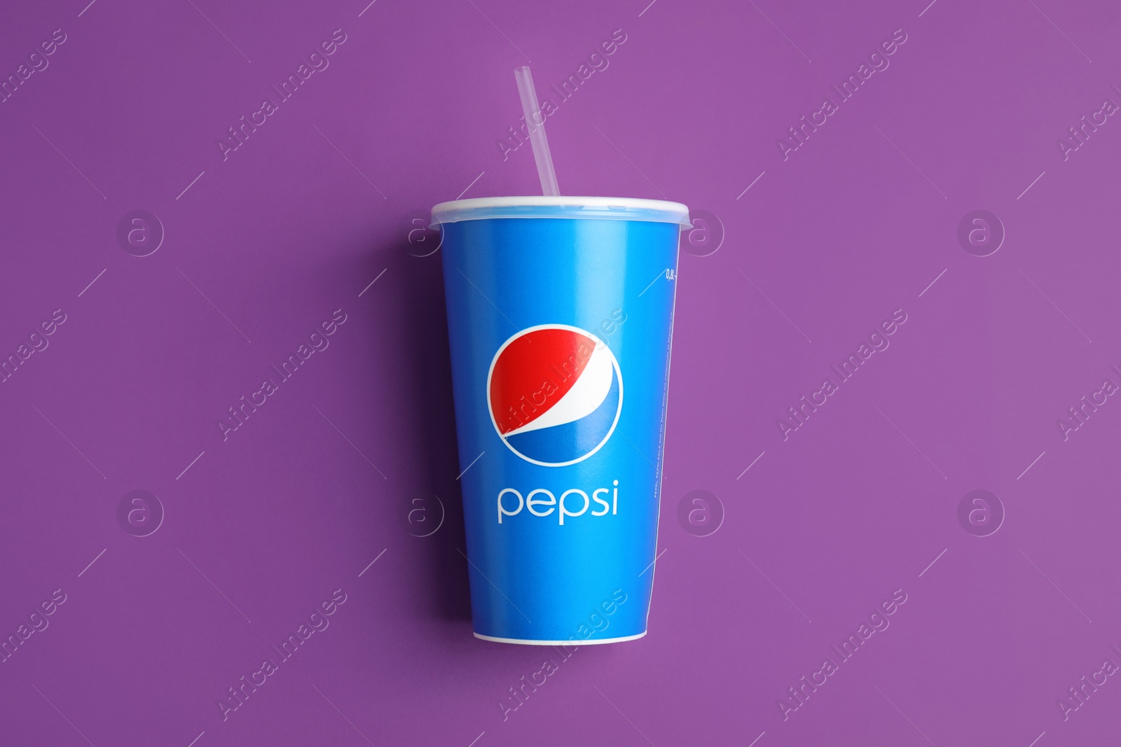 Photo of MYKOLAIV, UKRAINE - JUNE 9, 2021: Paper Pepsi cup on purple background, top view
