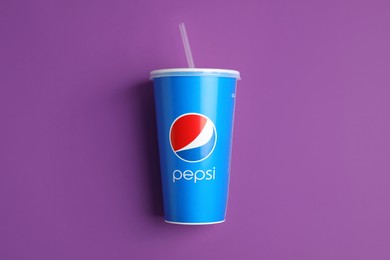 MYKOLAIV, UKRAINE - JUNE 9, 2021: Paper Pepsi cup on purple background, top view