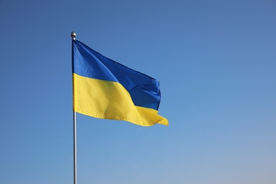 Photo of National flag of Ukraine against blue sky