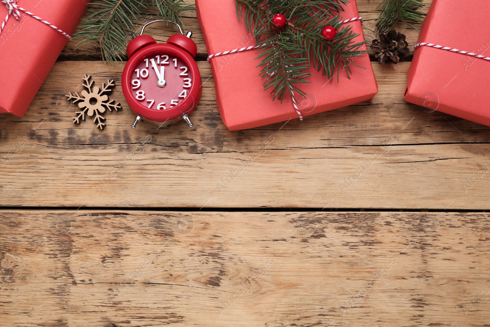 Photo of Flat lay composition with Christmas gifts and alarm clock on wooden table, space for text. Boxing day