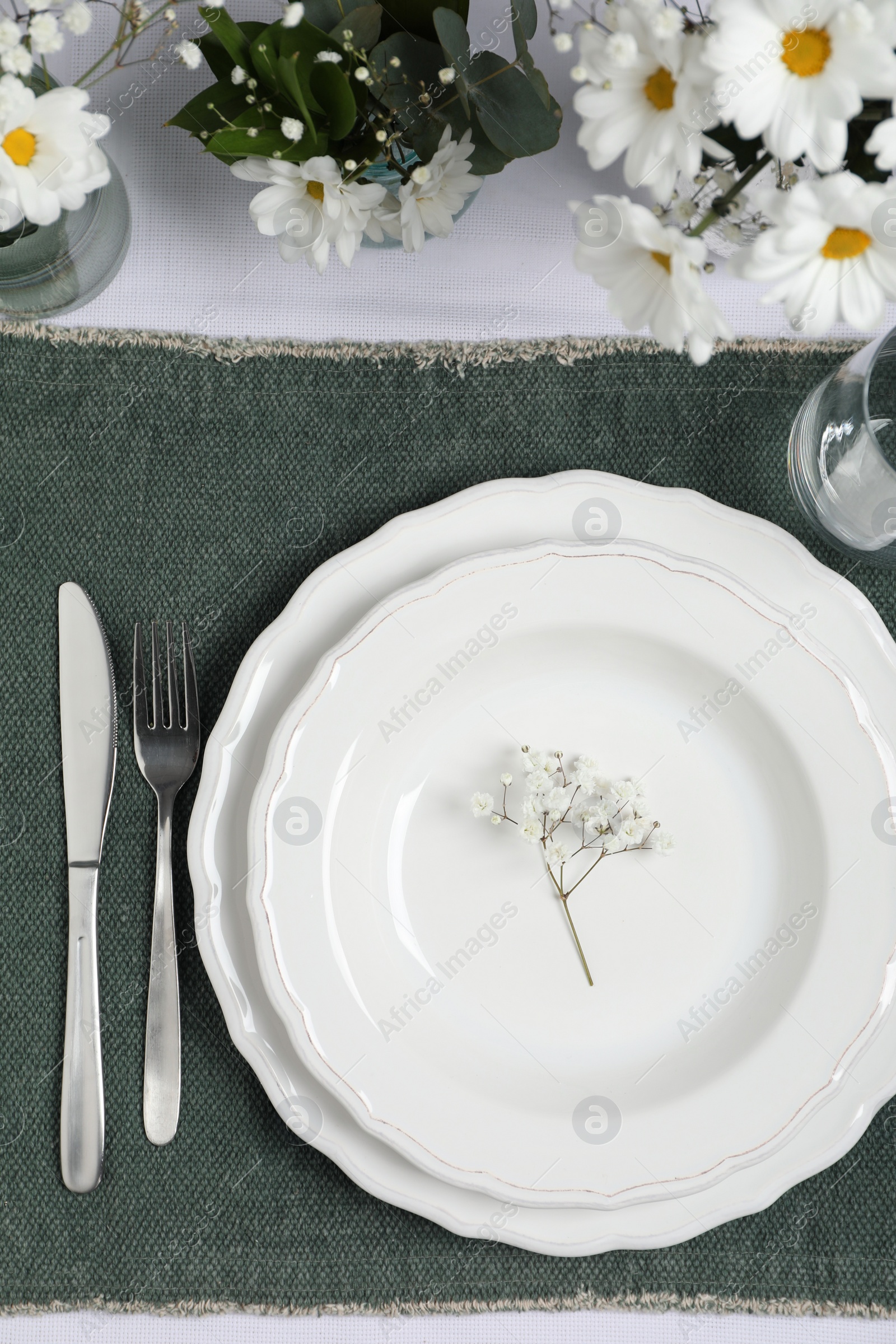 Photo of Elegant festive setting with floral decor on table, flat lay