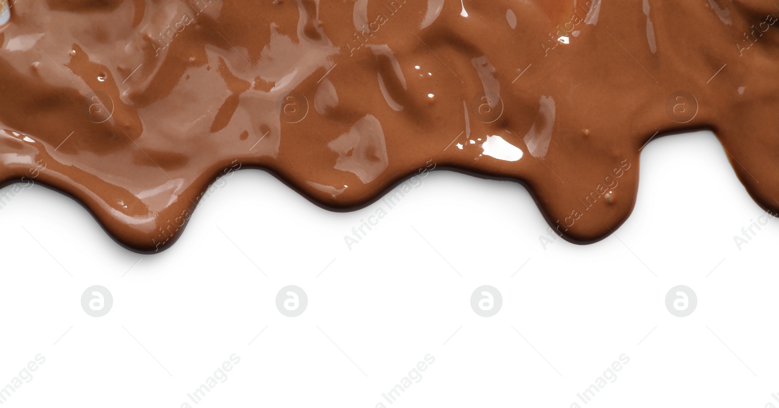 Photo of Tasty melted milk chocolate pouring down on white background