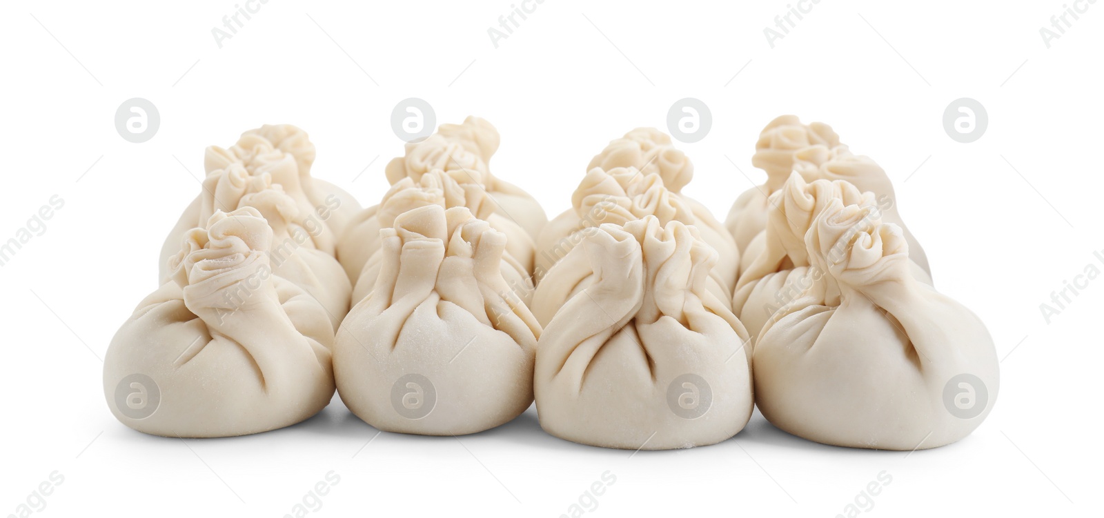 Photo of Uncooked khinkali (dumplings) isolated on white. Georgian cuisine