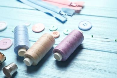 Photo of Set of tailoring accessories on wooden background