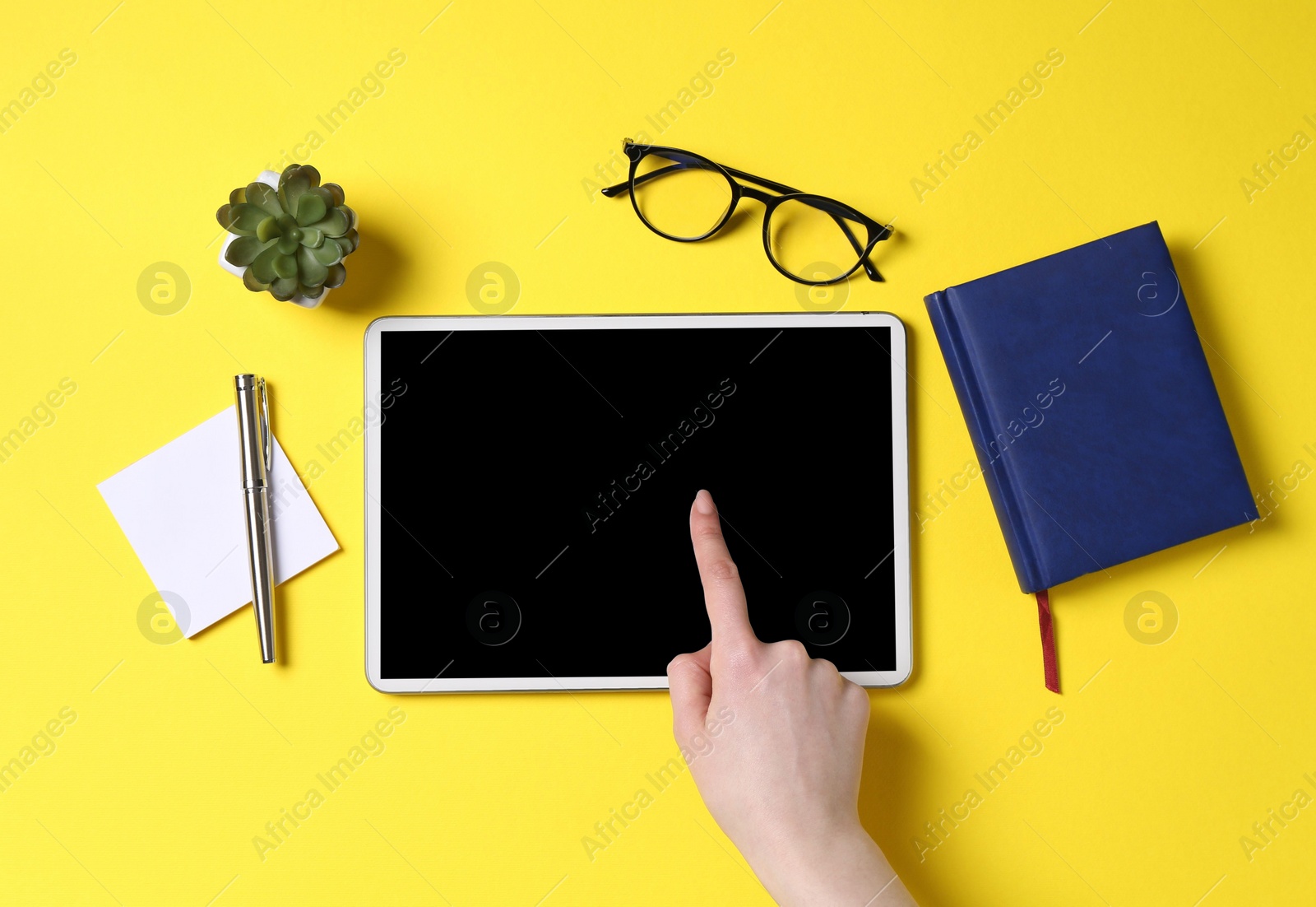 Photo of Online store. Woman using tablet on yellow background, top view