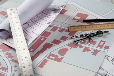 Photo of Office stationery on cadastral maps of territory with buildings